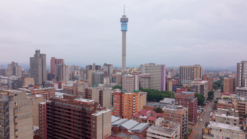 Aerial of Johannesburg and Hillbrow city buildings on overcast cloudy day.