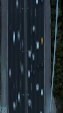 Tilt up reveal of busy multilane bridge over Bosporus and modern business buildings in distance. Augmented reality graphics providing data. Istanbul, Turkey