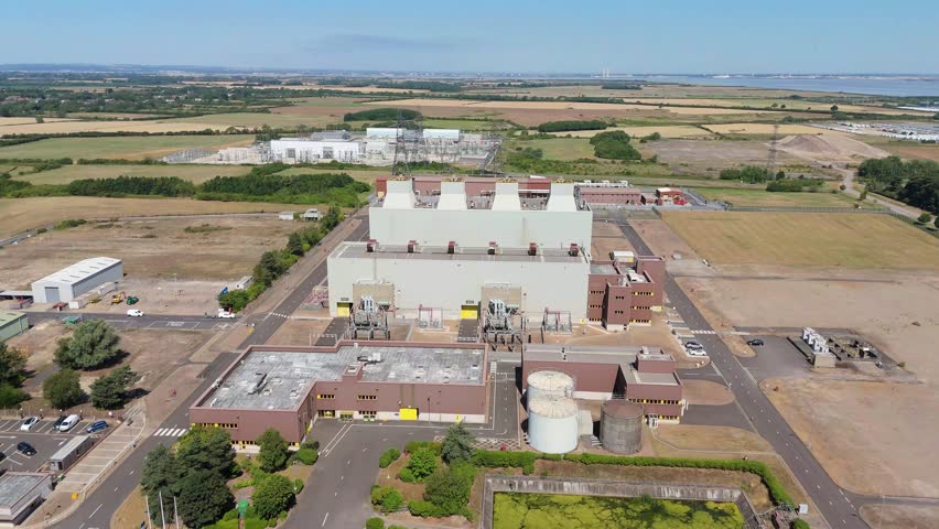 Aerial drone view of Killingholme power plant, with reactors, exhaust vents and powerlines pylons for generating electricity in Immingham, United Kingdom.