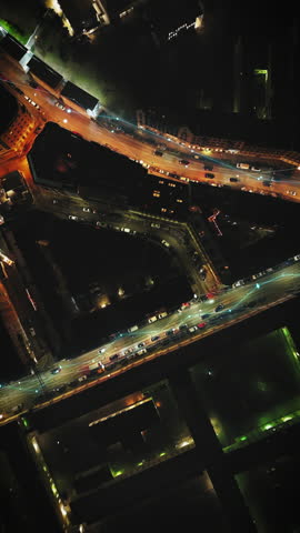 Birds eye ascending shot of cars driving in evening streets in urban borough. Fly above metropolis at night. Vienna, Austria. Added augmented reality visual effects