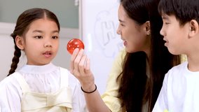 Teacher and students interact with geometric shapes, bright classroom lighting, close-up, educational activity - Powered by Shutterstock - Get 15% off with code: PIKWIZARD15