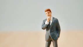 A Miniature Businessman Figurine Standing And Pondering Deeply On Stairs Made Of Coins, Captured With Natural Light And A Shallow Depth Of Field. - Powered by Shutterstock - Get 15% off with code: PIKWIZARD15