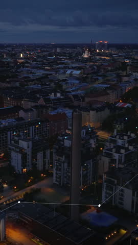 Apartment building in residential urban borough in evening. Backwards reveal of industrial facilities and halls. Helsinki, Finland. Added augmented reality visual effects