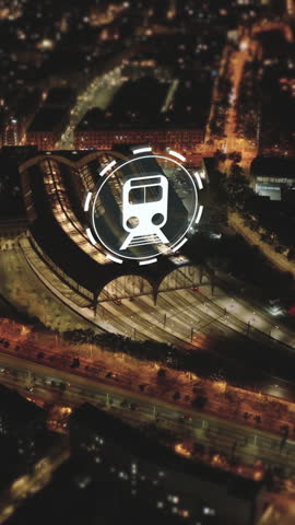 Evening high angle view of traffic on thoroughfare and Estacion de Francia train station. Visual effects representing arriving and leaving trains. Barcelona, Spain