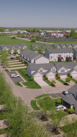 Aerial view of a suburban neighborhood with half of the houses painted in blue and half in red, symbolizing political affiliations during too-close-to-call US elections