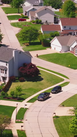 Aerial view of a US neighborhood with houses painted in Democratic blue and Republican red to show political support during too close to call elections