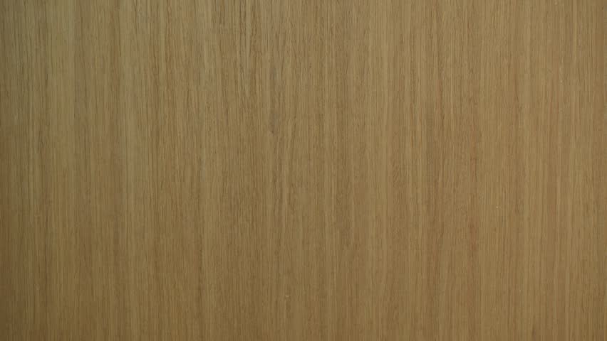 A humorous close-up shot of a pink sticky note on a wooden door with a misspelled correction, creating a light-hearted moment. Bright lighting highlights the playful message.