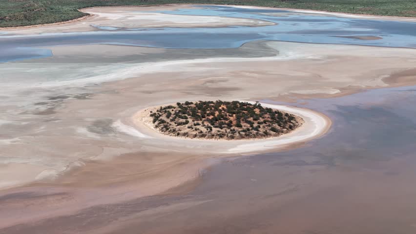 Aerial Lake Amadeus salty mud basin is the largest salt lake in Northern Territory Australia, about 50 km north of Uluru or Ayers Rock, stretching 180 kilometers long and 10 kilometers wide, salt lake