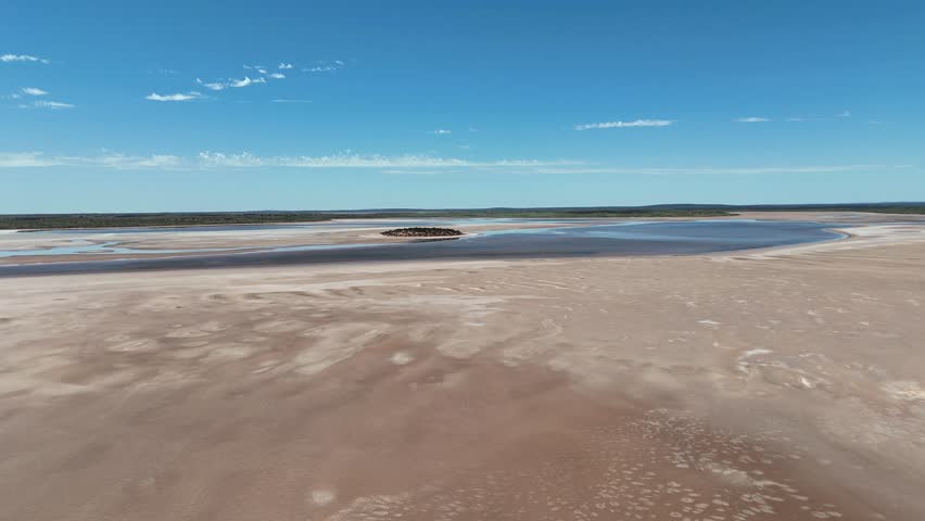 Aerial Lake Amadeus salty mud basin is the largest salt lake in Northern Territory Australia, about 50 km north of Uluru or Ayers Rock, stretching 180 kilometers long and 10 kilometers wide, salt lake