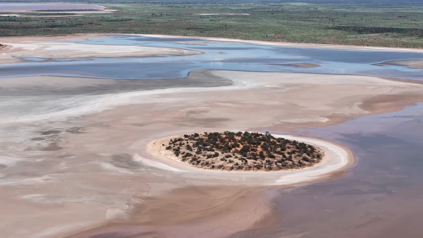 Aerial Lake Amadeus salty mud basin is the largest salt lake in Northern Territory Australia, about 50 km north of Uluru or Ayers Rock, stretching 180 kilometers long and 10 kilometers wide, salt lake