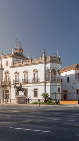 Plaza de Toros de la Real Maestranza de Caballeria de Sevilla timelapse hyperlapse. Traffic passing in front of its facade. Historic bullring in Seville, Spain, known for its bullfighting festivals.