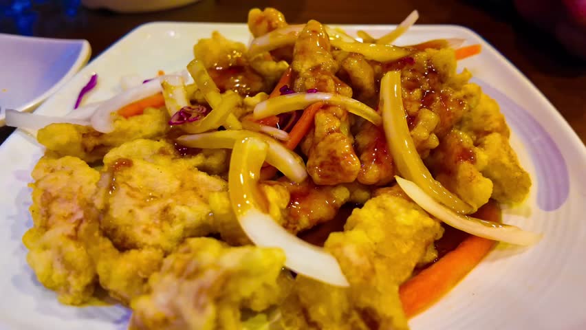 Sweet and sour sauce fried with pork tangsuyuk on dish in the restaurant