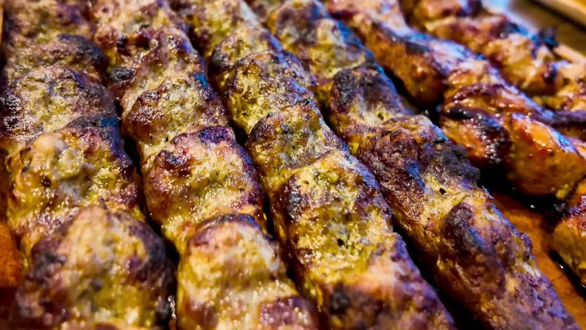 Tasty dish barbecue of meat with onion and sauce on plate, tasted with a fork