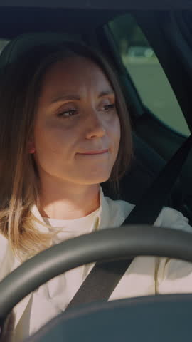 Nervous lady rushing to office and expressing impatience while waiting in car during traffic jam. Stressed brunette being late, checking time on hand watch and getting angry because of expectancy.