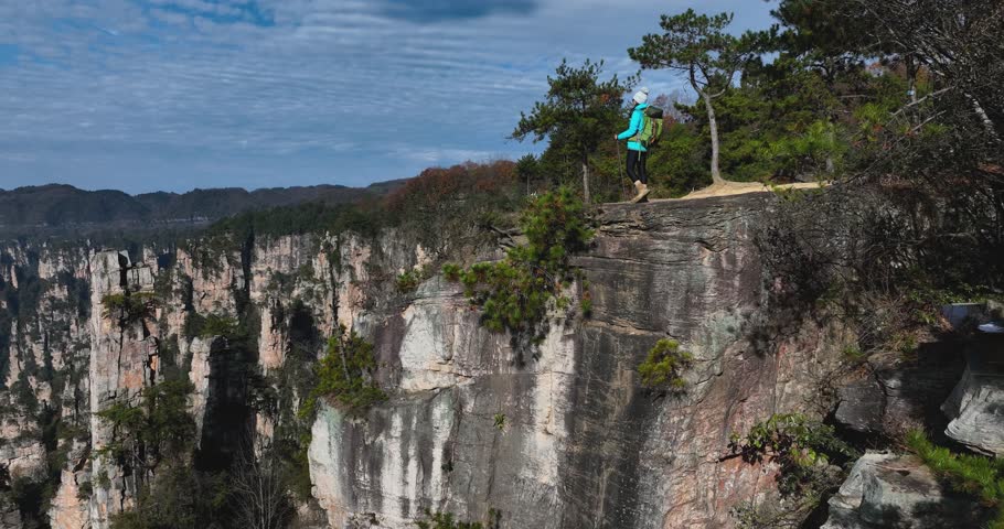 Female backpacker hiking in the sandstone mountains