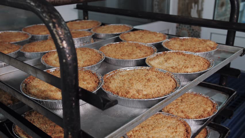 Fresh Apple Crumble Pies Cooling On Rack. Bakery production