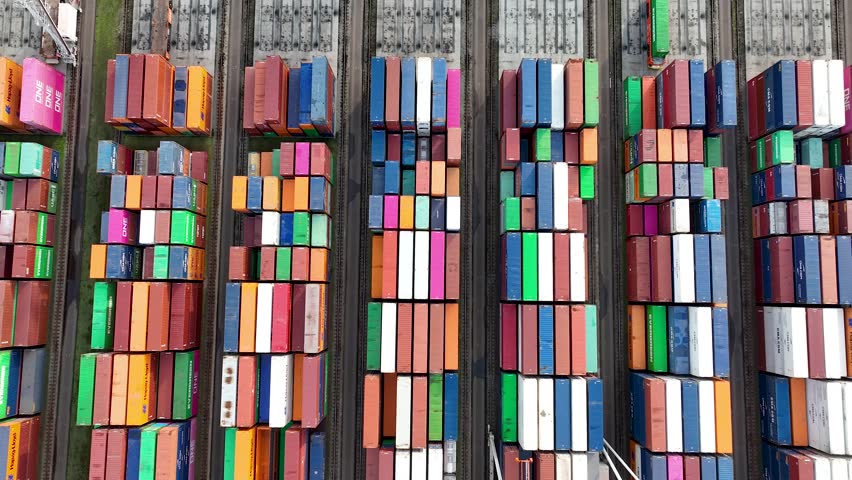 Drone shot of modern industrial container port of Rotterdam with containers from top view. It is an import and export cargo port where is a part of shipping dock. 4K