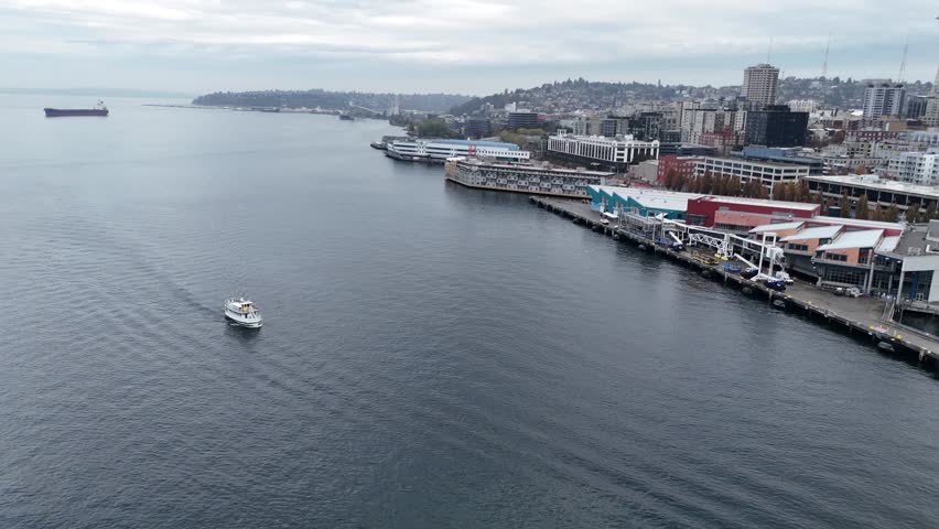 Drone over Elliott Bay and the ocean, capturing Seattle full skyline, waterfront, and cityscape cinematic aerial shot