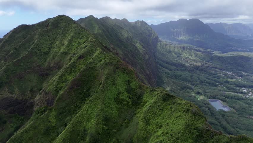 Aerial cinematic scenic view of Oahu, Hawaii, dramatic mountains peaks. Tropical island scenery with dense forest