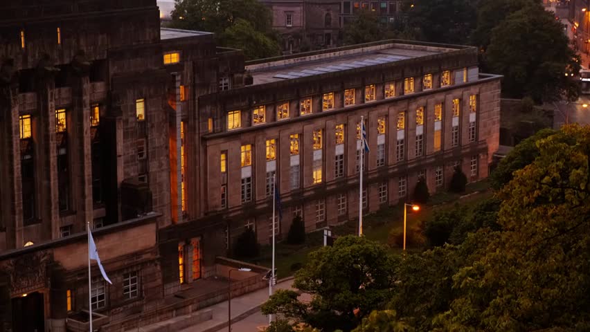 A dusk panorama captures historic and modern architecture, including a castle and government buildings, highlighting the skyline, urban charm, and scenic cityscape of a storied city.