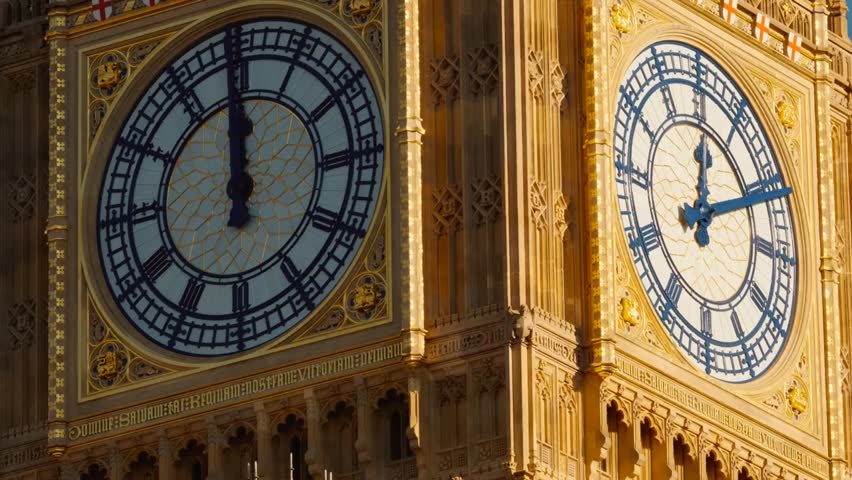 Closeup of fully restored clock faces on a historic tower, showcasing intricate design, architectural detail, and the precision craftsmanship of a landmark timepiece.