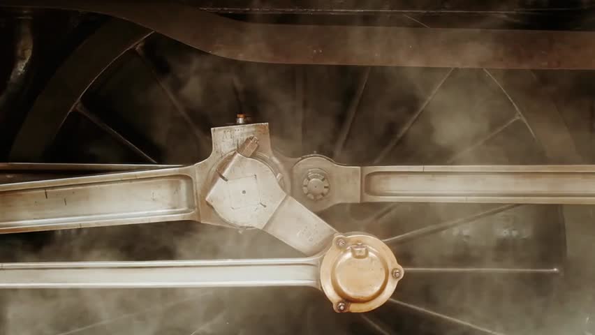 A closeup of a vintage steam locomotive highlights the engine details, moving wheels, and billowing steam, capturing the power, mechanics, and nostalgic charm of classic rail travel.