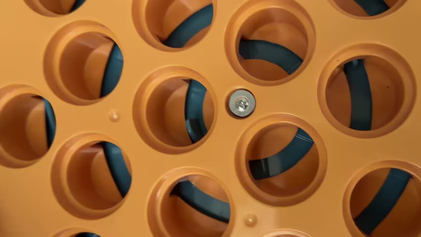 Industrial equipment with a detailed view of a rotating mechanism inside an automatic wine bottling machine, showcasing the synchronization and precision required for modern production processes