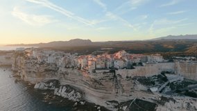 Aerial view of coastal sunset City, peaceful mediterranean coastal community with terracotta roofs during sunset. Bonifacio. France - Powered by Shutterstock - Get 15% off with code: PIKWIZARD15