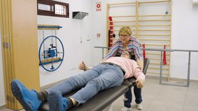 Professional physiotherapist treating a male patient's neck pain. Medical expert performing manual therapy and muscle stretching on a man - Powered by Shutterstock - Get 15% off with code: PIKWIZARD15