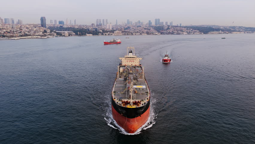 A powerful ship heads toward Istanbul’s skyline, framed by the hills and modern towers of the European side.