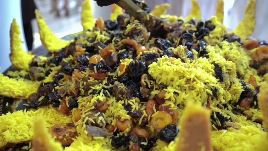 Mixing opened pilaf with Dried Apricots and Prunes