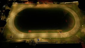 Aerial view of an empty stadium with running track at night. Floodlights, architecture, sports. Perfect for sports, architecture, night themes. Commercial use. - Powered by Shutterstock - Get 15% off with code: PIKWIZARD15