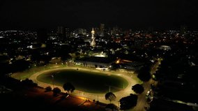 Aerial night view of an illuminated stadium with running track and city skyline. Sports, architecture, night. Perfect for sports, architecture, commercial themes. - Powered by Shutterstock - Get 15% off with code: PIKWIZARD15