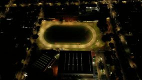 Aerial view of an empty stadium with running track at night. Floodlights, architecture, sports. Perfect for sports, architecture, night themes. Commercial use. - Powered by Shutterstock - Get 15% off with code: PIKWIZARD15