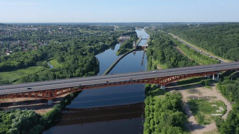 Aerial Highway Crossing over Reflective River