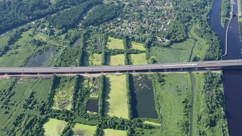 Aerial Highway over Canal Surrounding Green Fields