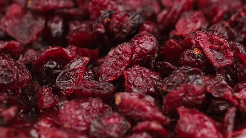 Close-up views highlight the rich color and chewy texture of dried cranberries.