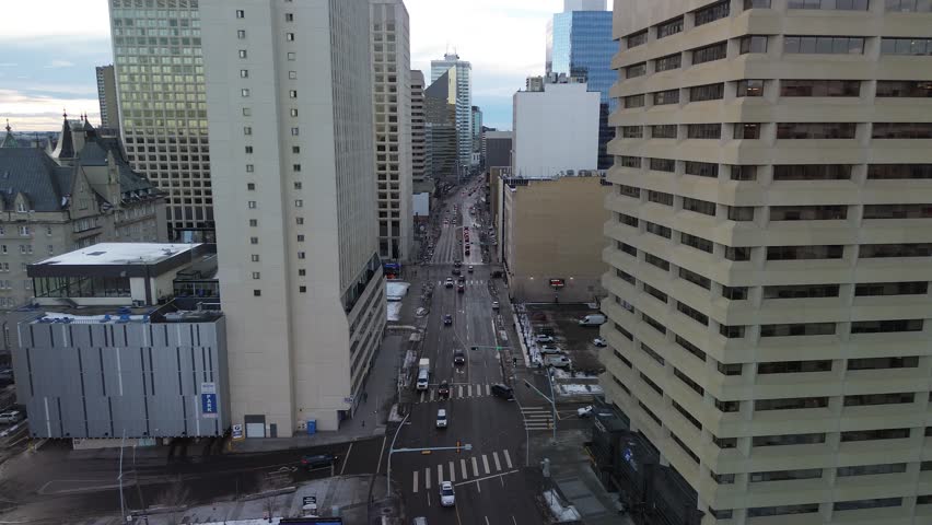 Aerial view of Edmonton’s downtown skyline during winter, highlighting tall skyscrapers, dense urban structure and snowy streets.