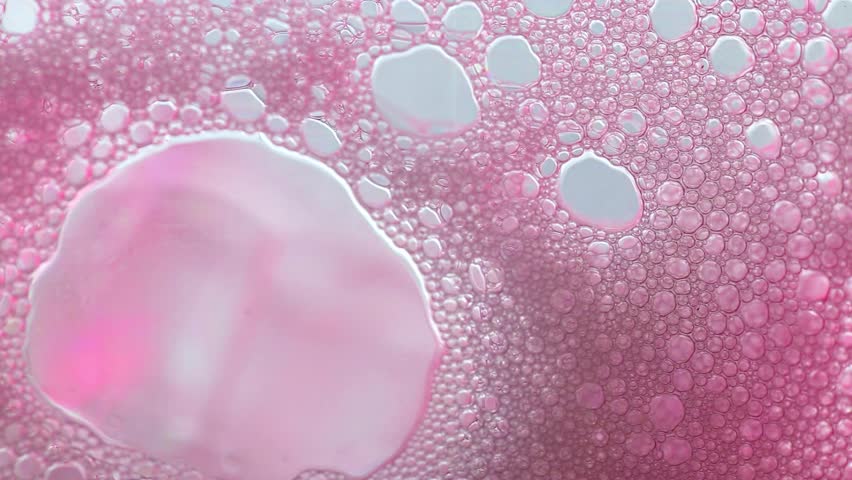 Pink Cosmetics texture macro.Pink bubbles of soap foam flow down.Cleanliness and hygiene background. Foam Water Soap Suds.Texture Foam 