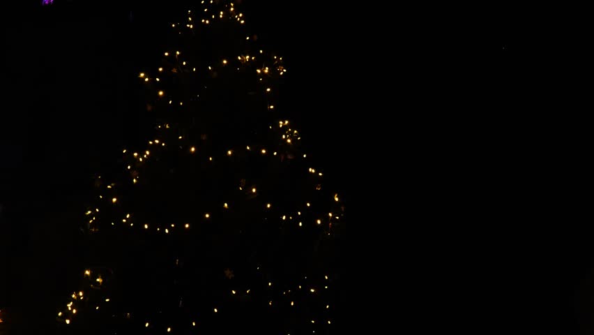Christmas wallpaper in minimalist style.Christmas tree silhouette made of garlands on a dark sky background.Christmas and New Year mood. 4k footage - Powered by Shutterstock - Get 15% off with code: PIKWIZARD15