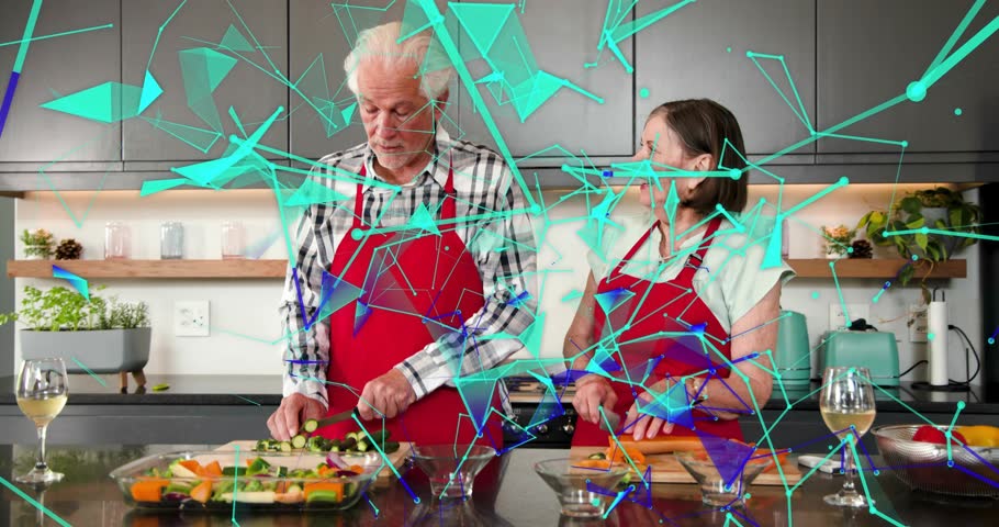 Senior couple cutting on island smiling reaching for wine toasting cooking teal overlay hiding view. Elderly, duo, kitchen, vegetables, apron, meal, prep