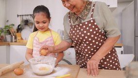 Asian granddaughter baking bakery with grandmother in kitchen at home. Happy family, adorable kid girl enjoys spending quality leisure time with caring senior mature grandma in cozy house together. - Powered by Shutterstock - Get 15% off with code: PIKWIZARD15