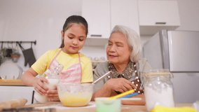 Asian granddaughter baking bakery with grandmother in kitchen at home. Happy family, adorable kid girl enjoys spending quality leisure time with caring senior mature grandma in cozy house together. - Powered by Shutterstock - Get 15% off with code: PIKWIZARD15