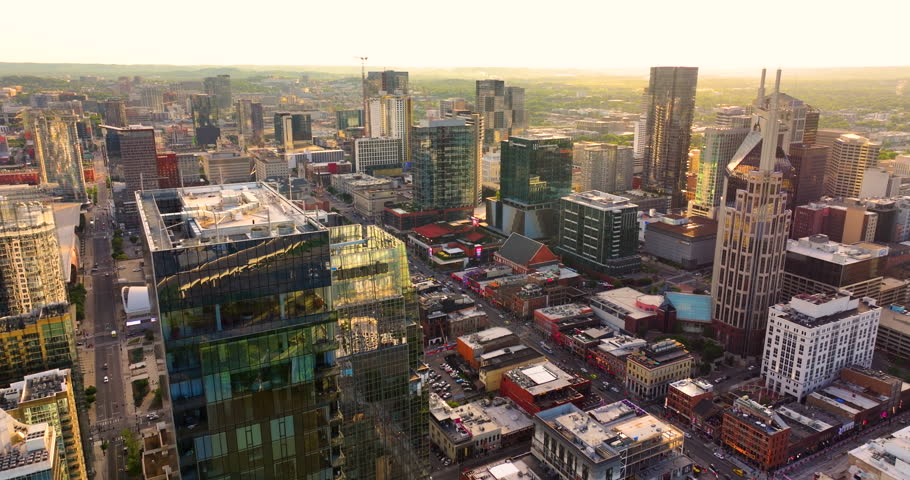 Aerial panorama of downtown Nashville, Tennessee at sunset with modern skyscrapers in developing city.