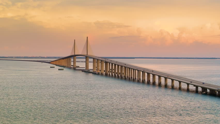 Sunshine Skyway Bridge in Florida, USA at sunset. Driving traffic over Tampa Bay