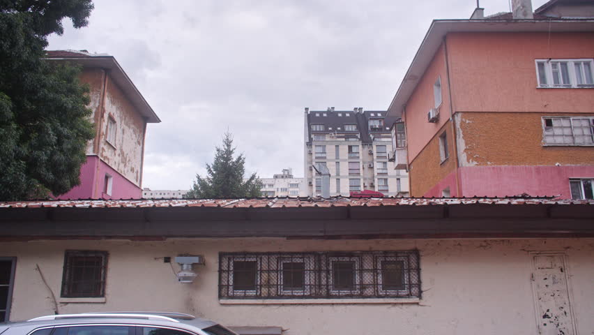A neighborhood with communist architecture apartment buildings and the surrounding neighborhood environment, parks and trees from the communist era on the Balkans in Sofia, Bulgaria, Eastern Europe.