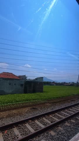 Vertical Footage, View of the slums along the train tracks from a passenger