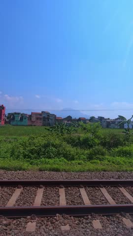 Vertical Footage, View of the slums along the train tracks from a passenger