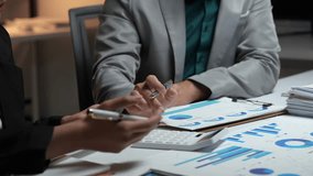 Close up of professional colleagues analyzing financial data charts and graphs during a meeting - Powered by Shutterstock - Get 15% off with code: PIKWIZARD15