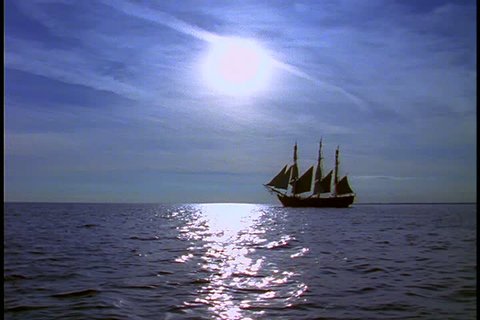 Historical reenactment of HMS Bounty ship on Rhode Island. LS silhouette of Bounty under full sail. 